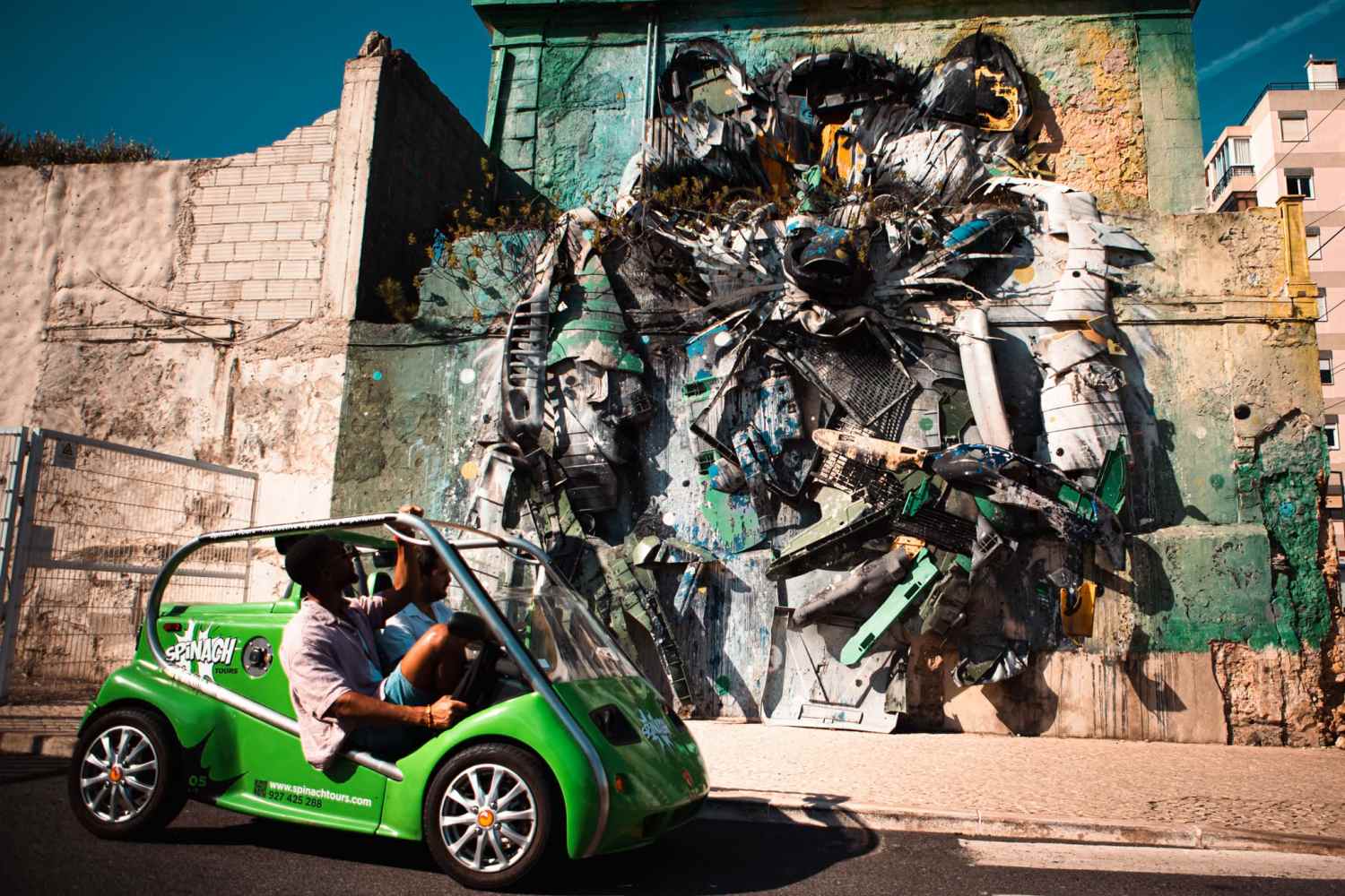 Street art tour with Spinach Tours passing by a Bordalo masterpiece in Lisbon